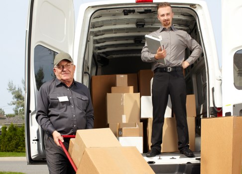 Loading furniture into a van for a home relocation in Brent