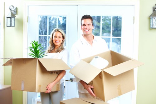 Mover wearing PPE while loading items into a removal van